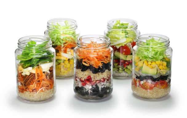 Salad in glass jar on white background, no lid - Photo, Image