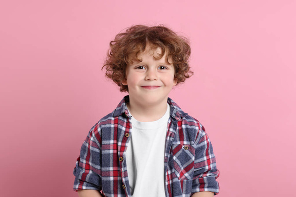 Portrait of cute little boy on pink background - Фото, зображення