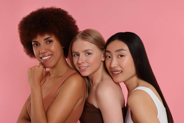 Portrait of beautiful young women on pink background - Photo, image