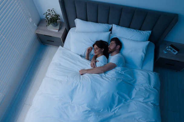 Lovely couple sleeping together in bed at night, top view - Foto, Imagem
