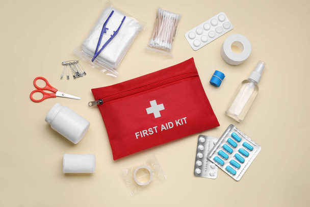 Flat lay composition with first aid kit on beige background - Fotografie, Obrázek