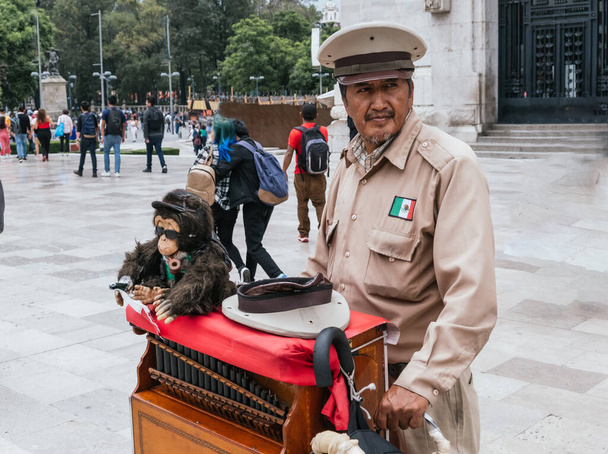 Mexican organ grinder playing his instrument outside the Palace of Fine Arts in Mexico City - Photo, Image