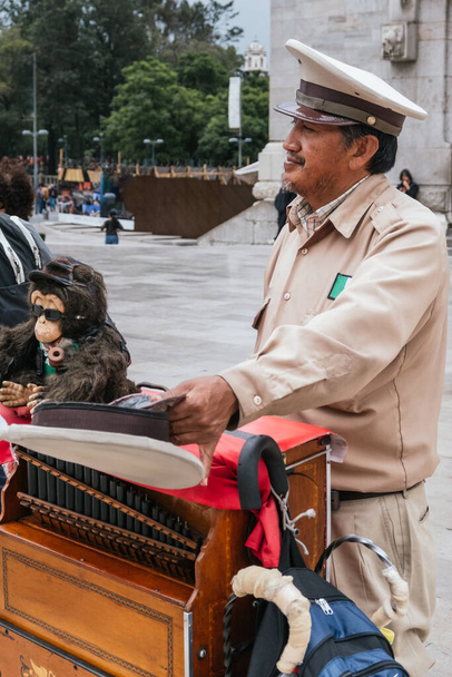 Mexican organ grinder playing his instrument outside the Palace of Fine Arts in Mexico City - Photo, Image