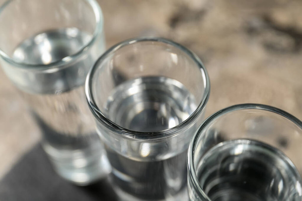 Glasses of vodka on grey background - Photo, Image