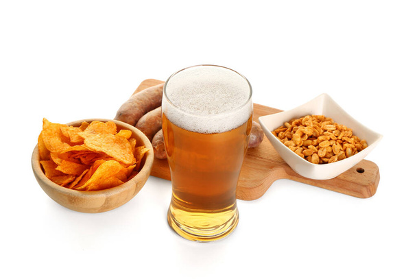 Glass of cold beer and different snacks on white background. Oktoberfest celebration - Foto, immagini