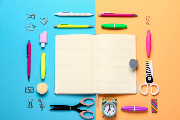 Notebook with different stationery supplies on colorful background - Φωτογραφία, εικόνα