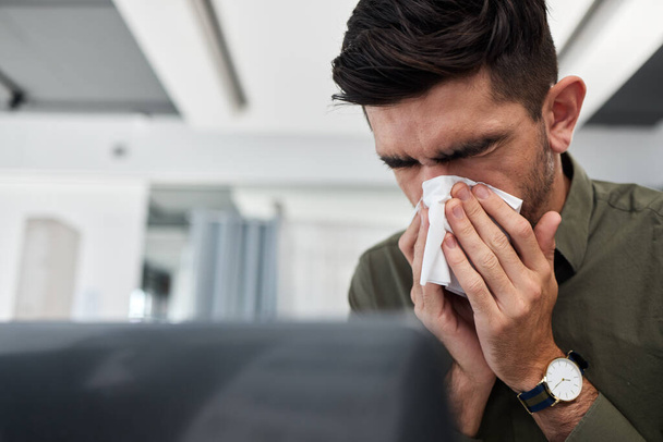 Business man, blowing nose and tissue in office with flu, mucus or allergies for healthcare problem. Sick entrepreneur, toilet paper and cleaning for wellness, workplace and virus with cold bacteria. - Photo, Image