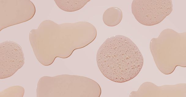 Druppels en uitstrijkjes van cosmetica in verschillende maten. Druppels vloeibare gel met belletjes op een beige achtergrond. Banner - Foto, afbeelding