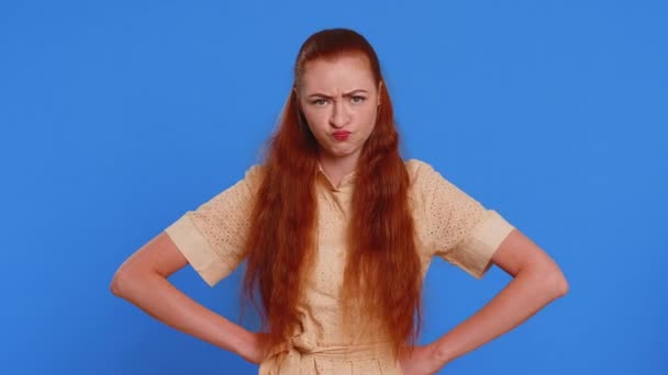 Offended sad nervous woman having misunderstanding, frustrated after quarrel, fail, lose, ignores and does not want to communicate, talk. Redhead girl isolated on blue background. People lifestyles - Footage, Video