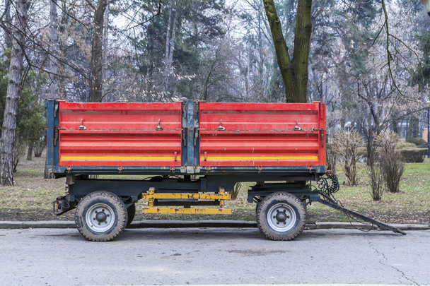 Red municipality trailer ready for park maintenance on alley - Photo, Image