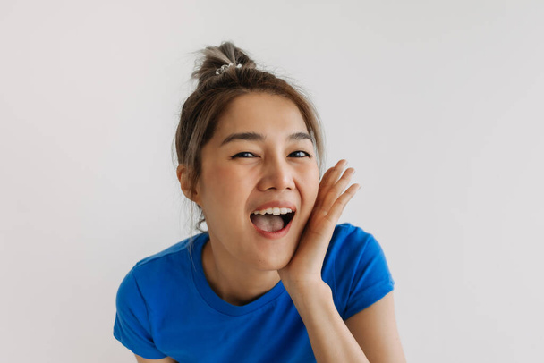 Close up portrait of happy and cheerful asian woman isolated on white. - 写真・画像