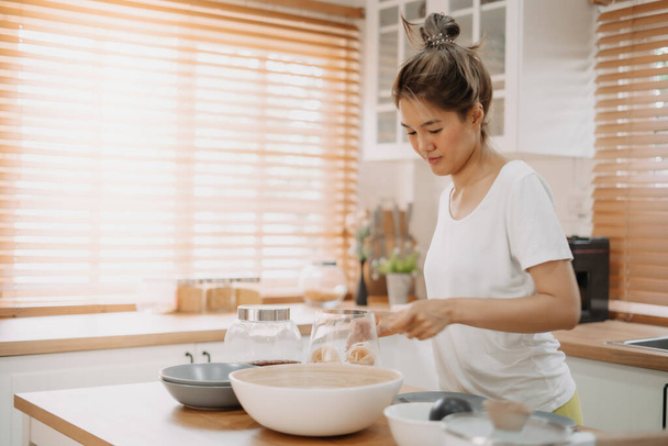 Asian wife cooking and prepare noodle meal for husband in the kitchen. - 写真・画像