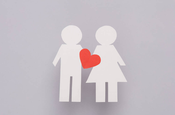 Love concept. Paper cut couple in love with a heart on a gray background - Photo, Image