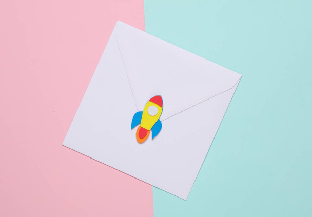 Postal Envelope with a space rocket on pink blue background. - Photo, Image