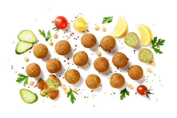 Chickpea falafel balls with hummus, vegetables  and lemon slices. isolated on white background, top view - Photo, image