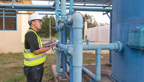 Environmental engineers work at wastewater treatment plants,Male plumber technician working at water supply - Valokuva, kuva