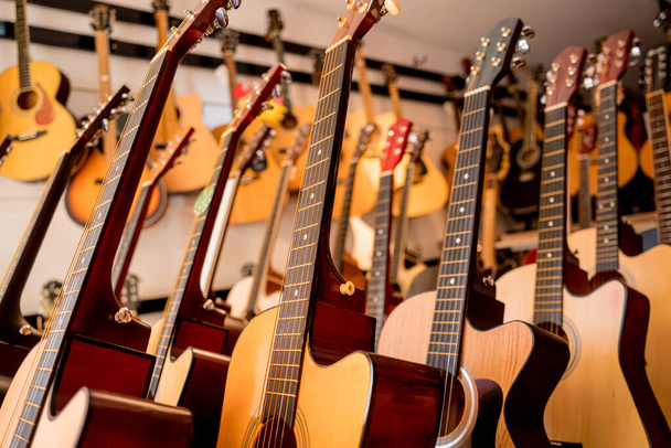 Many rows of classical guitars in the music shop. - Photo, Image
