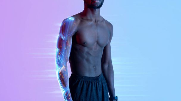 Cropped view of handsome young black sportsman with naked torso posing in neon light. Sexy athletic African American bodybuilder with prominent abs muscles, web-banner for digital sport concept - Фото, изображение