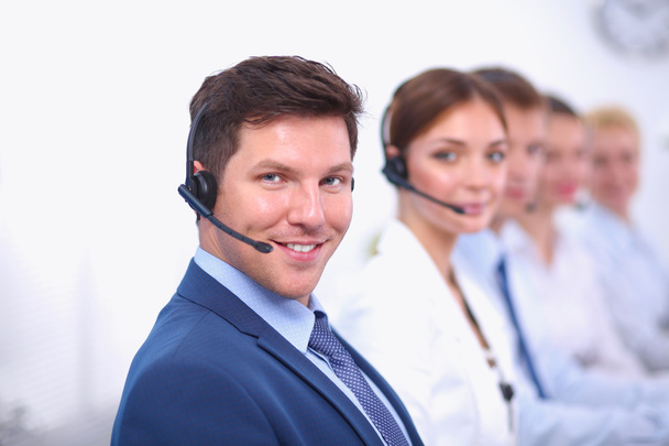 Attractive Smiling positive young businesspeople and colleagues in a call center office - Photo, Image
