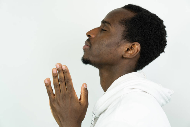 young black man praying, isolated on white background - Photo, Image