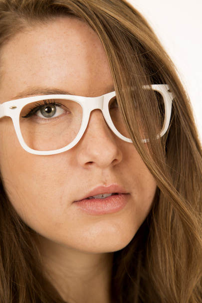 Young female model portrait wearing white glasses hair in face - Photo, Image