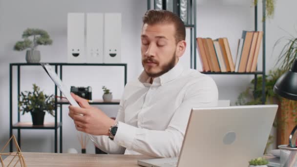 Young middle eastern boss business man making online presentation video call, demonstrates graphic analytics, planning budget, statistic. Freelancer guy at office workplace looking at camera, talking - Footage, Video