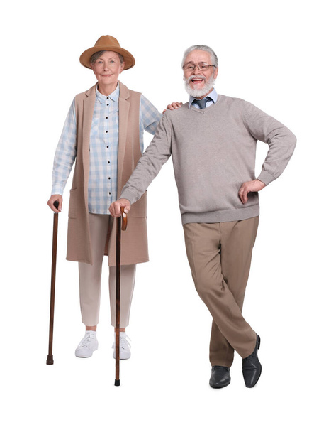 Senior man and woman with walking canes on white background - Fotoğraf, Görsel