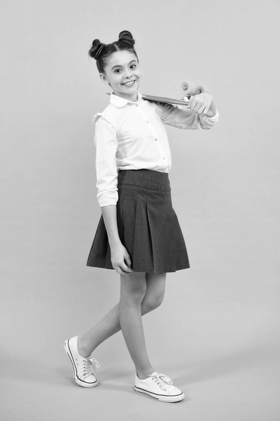 Teen hipster girl skater with skateboard on isolated background. Summer kids trend, urban teenage style - Foto, Imagem