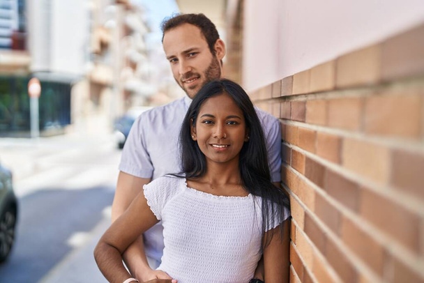 Man and woman interracial couple standing together at street - Photo, Image