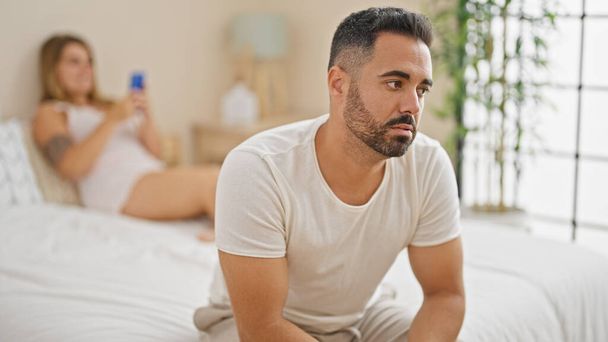 Man and woman couple sitting on bed with problems at bedroom - Photo, Image