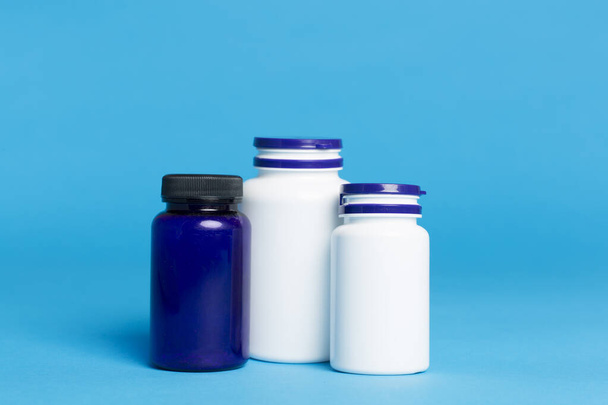 Plastic bottles for vitamins on color background - Photo, Image