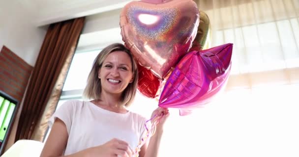 Happy smiling woman holding many colorful balloons 4k movie slow motion. Happy Birthday concept - Metraje, vídeo