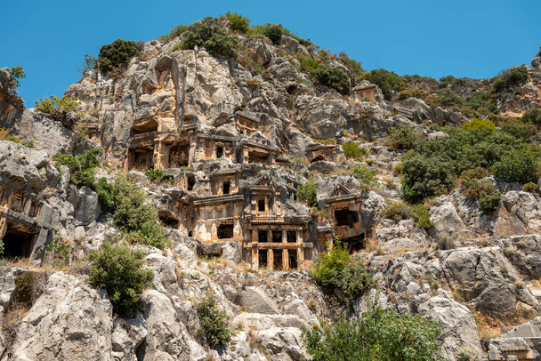 The ruins of the amphitheater and ancient rock tombs in the ancient city of Myra in Demre, Turkey - Photo, Image