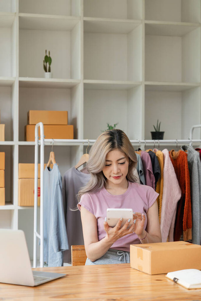 Startup small business entrepreneur SME, asian woman check order. Portrait young Asian small business owner home office, online sell marketing delivery, SME ecommerce concept. - 写真・画像