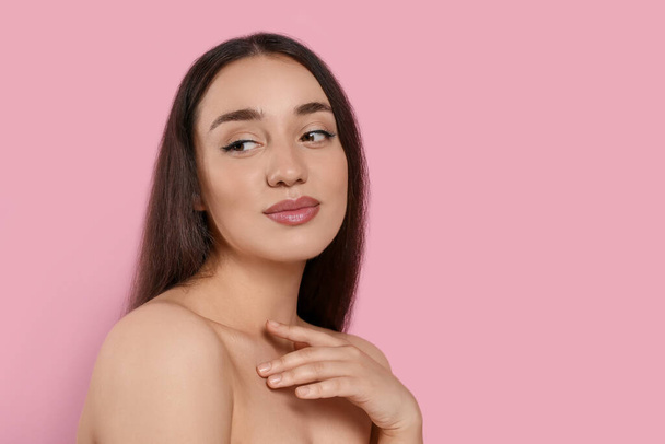 Portrait of beautiful young woman with elegant makeup on pink background. Space for text - Fotó, kép