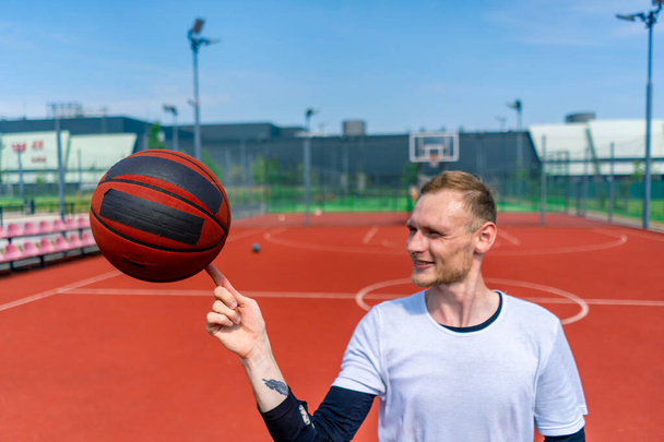 Close-up of guy basketball player spinning a basketball on his finger showing his basketball freestyle skills - Photo, Image