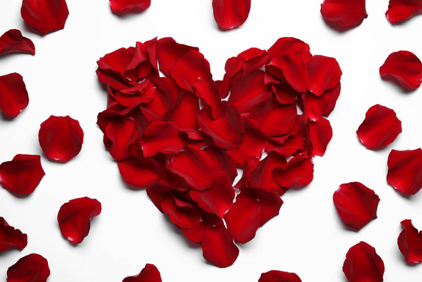 Beautiful heart of red rose petals on white background, top view - Fotó, kép