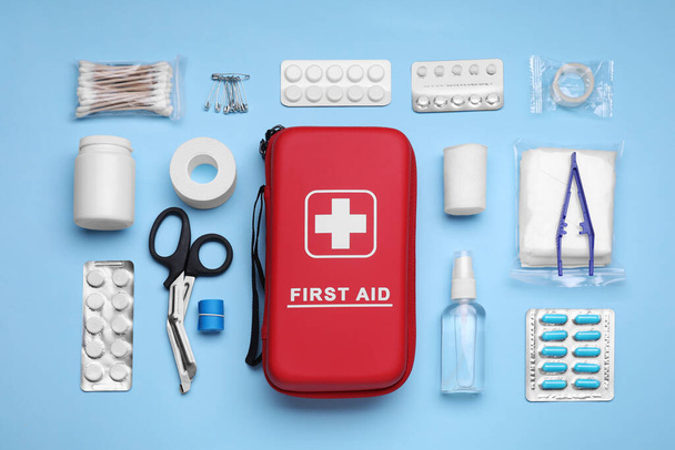 Flat lay composition with first aid kit on light blue background - Foto, immagini