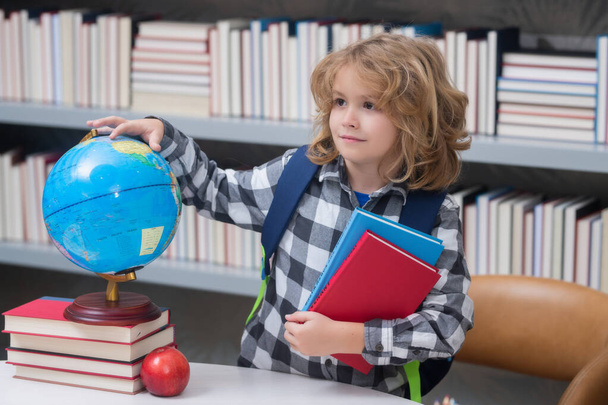 Child from elementary school with book. Little student, clever nerd pupil ready to study. First time to school. Concept of education and learning - Foto, Imagen