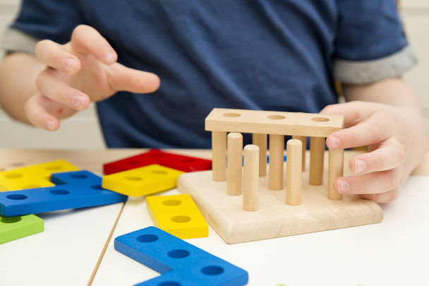 Matching the shapes. 3D wooden constructor. Implement for learning to count. Addition and subtraction exercises. Montessori methodology for nursery and preschool children. - Φωτογραφία, εικόνα