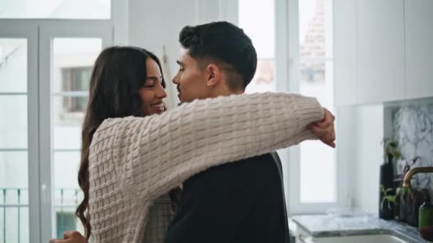 Affectionate people embracing at light kitchen closeup. Intimate boyfriend girlfriend romantic morning. Lovers enjoying warm cuddles at modern apartment. Latina couple spending weekend together - Footage, Video