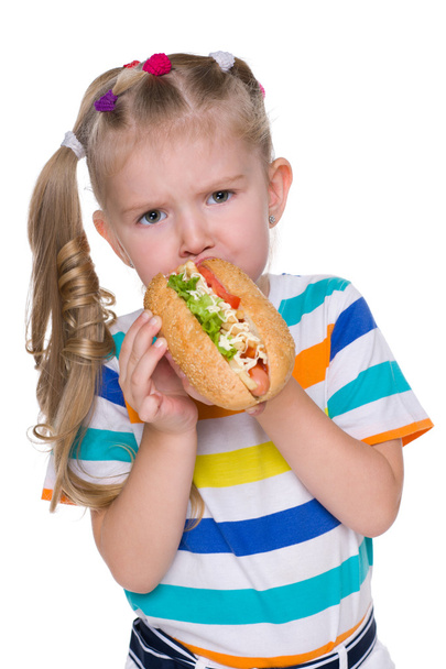 Little girl eats hot dog - Photo, Image