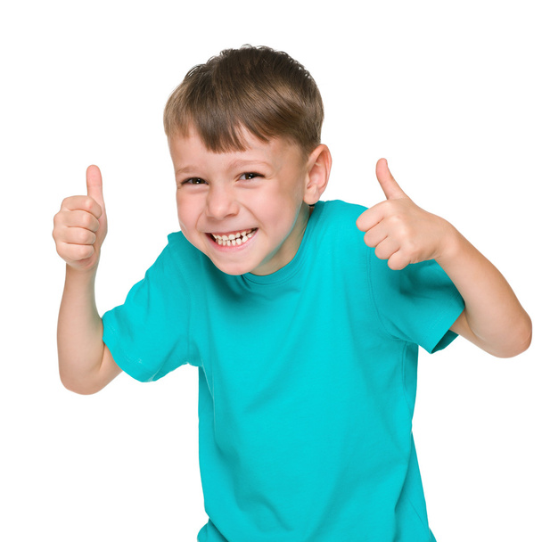 Laughing little boy holds his thumbs up - Foto, Imagem