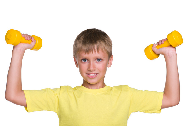 Young boy does exercises with dumbbells - Foto, Imagen