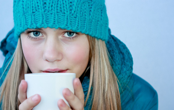 Girl with a cup of hot tea - Фото, изображение