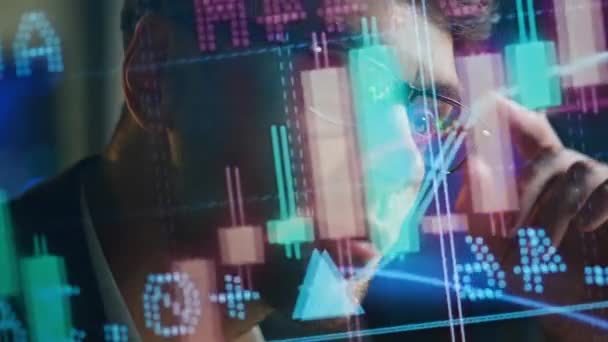Focused businessman analysing sales in futuristic investment hologram closeup. Thoughtful man stock market manager planning financial strategy business profit. Serious busy trader work late in office - Footage, Video