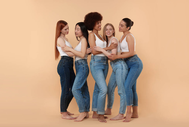 Group of beautiful young women on beige background - Photo, Image