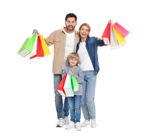 Family shopping. Happy parents and son with many colorful bags on white background - Fotografie, Obrázek