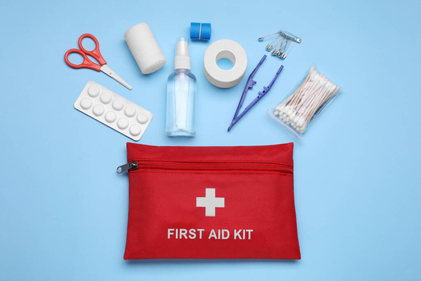 Flat lay composition with first aid kit on light blue background - Fotografie, Obrázek