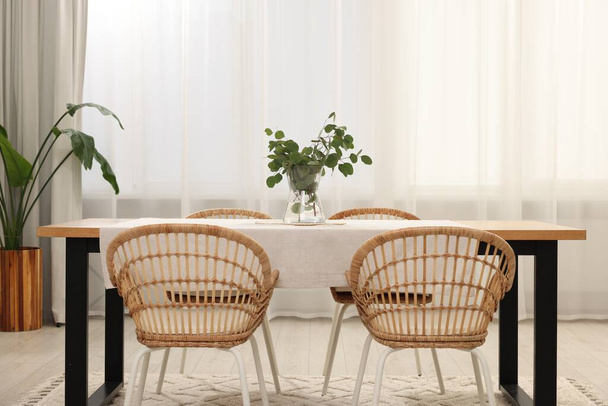 Stylish dining room with cozy furniture and plants - Zdjęcie, obraz